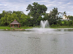 lake with fountain and gazebo